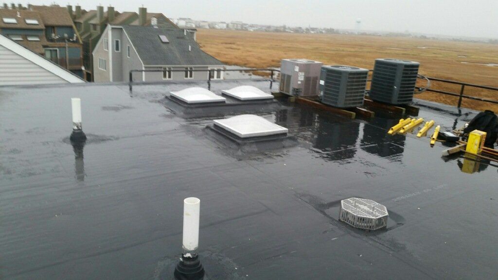 The roof of a building with a lot of air conditioners on it