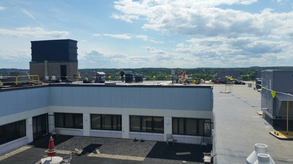 An aerial view of a large building with a large roof.