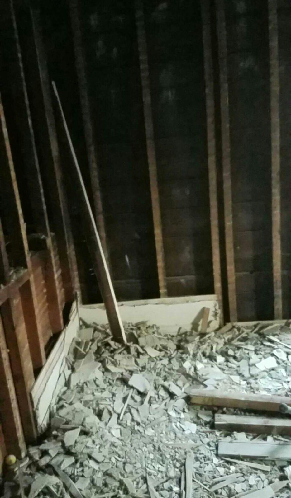 A room with a lot of broken pieces of wood on the floor.