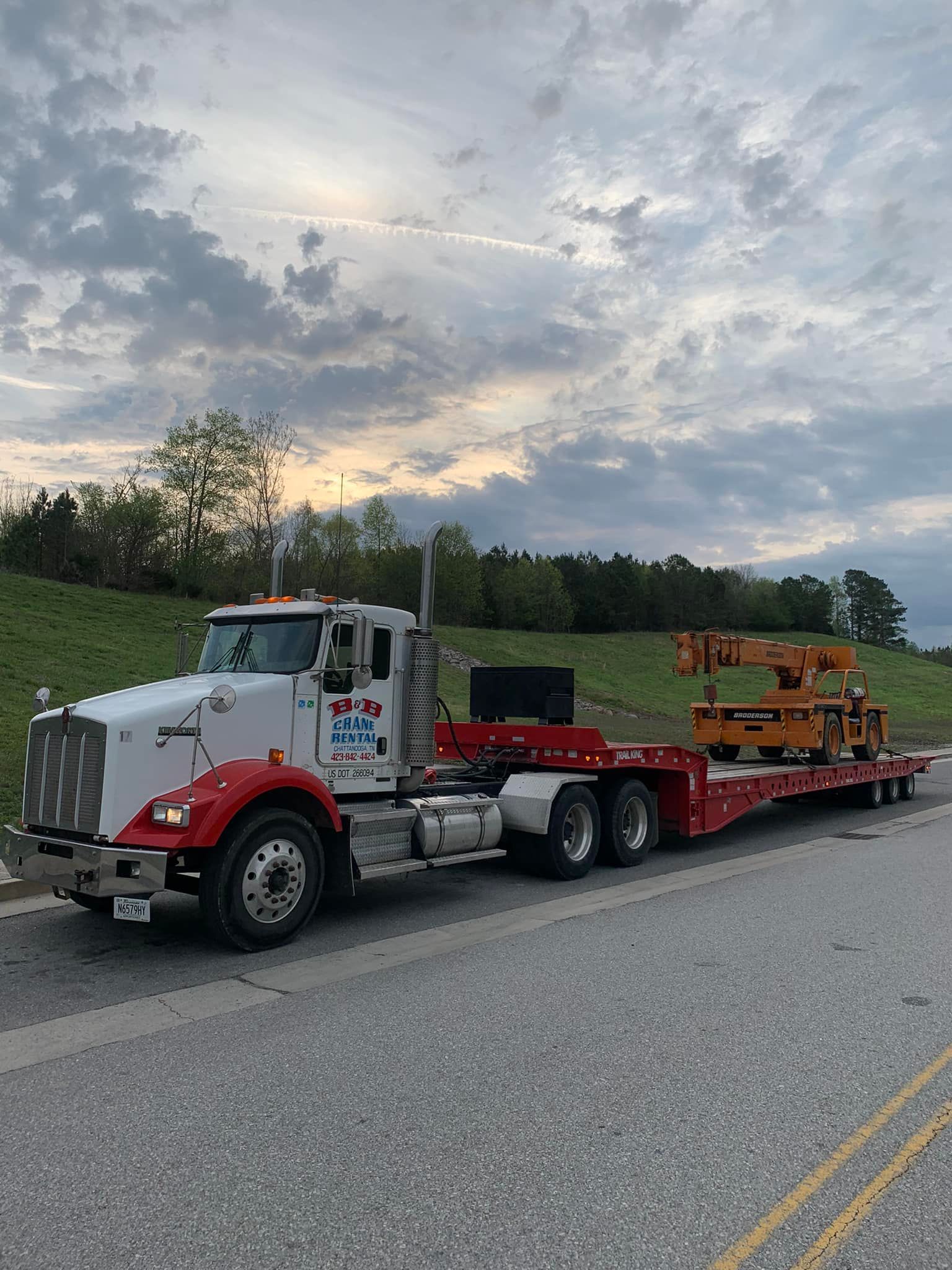 A semi truck is parked on the side of the road.