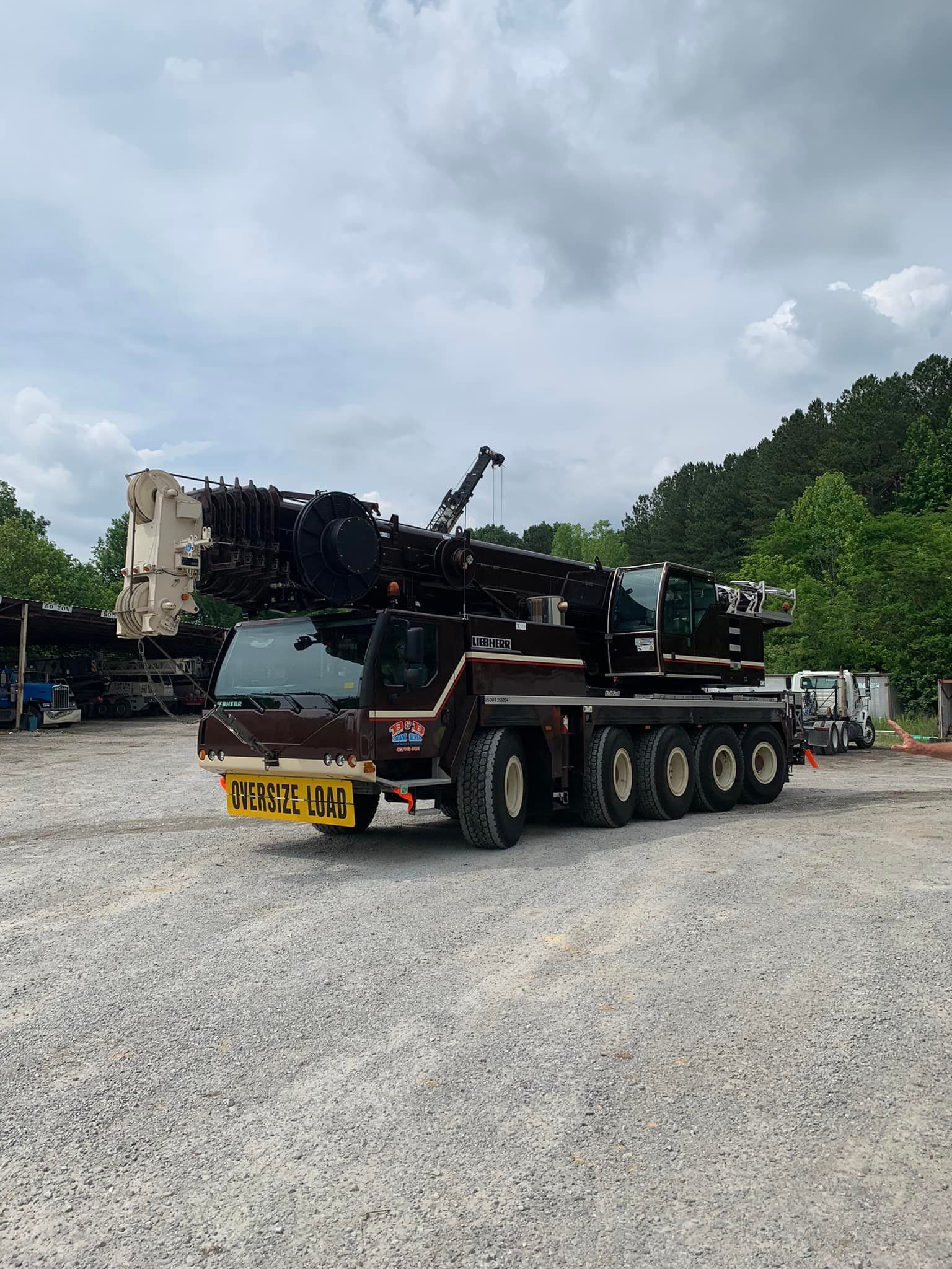 A large crane is parked in a gravel lot.