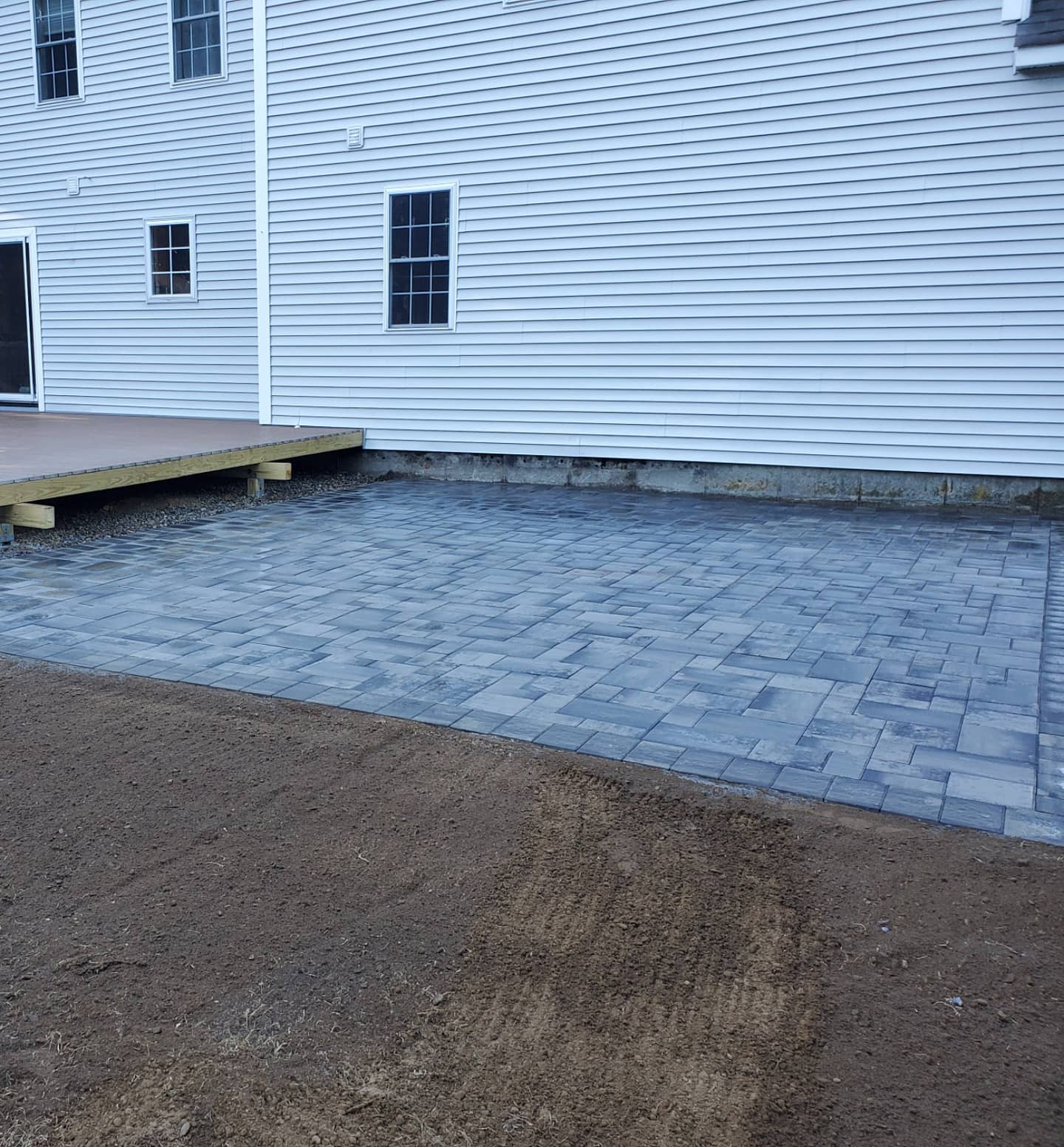 a white house with a patio in front of it .