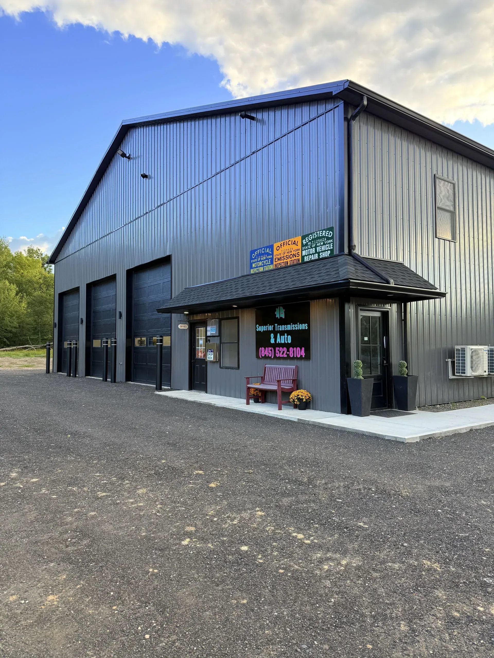 Exterior of a metal building with a small entryway. Sign says 