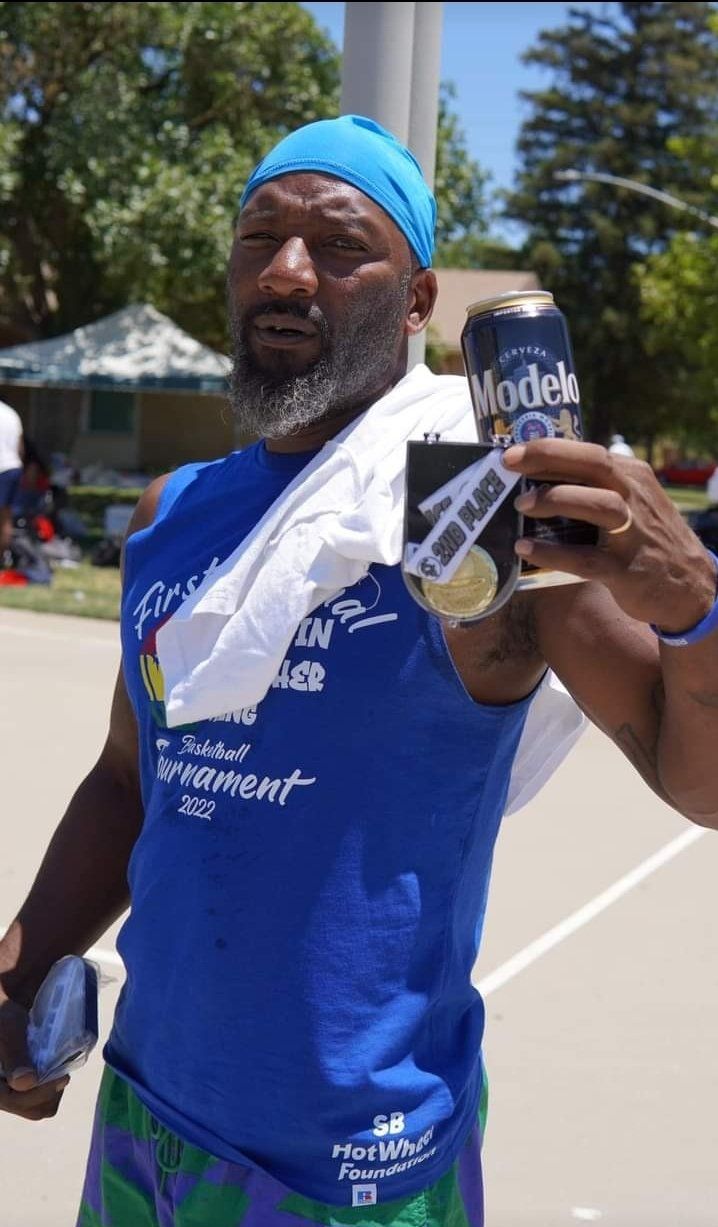 man with 2nd place award with beer on hand