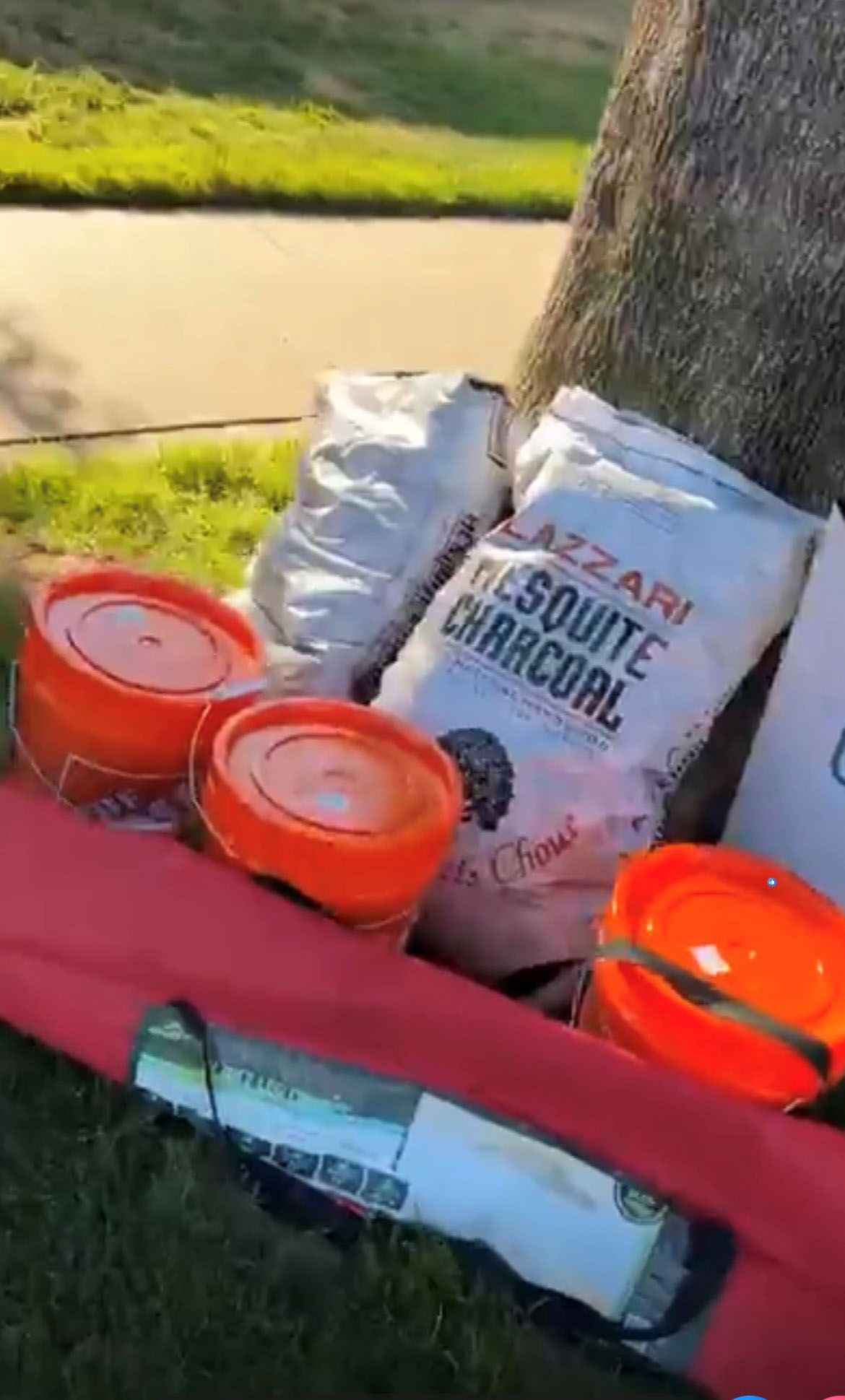 A bag of charcoal sits on top of a pile of other items