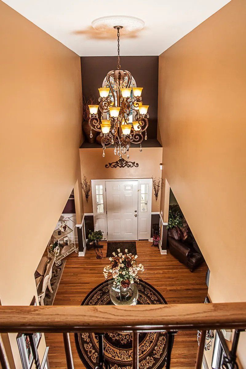 chandelier installation in hallway