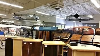 Wooden stairs leading down, with wood paneling at the bottom and white walls on either side.