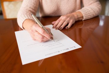 Woman Signing Papers
