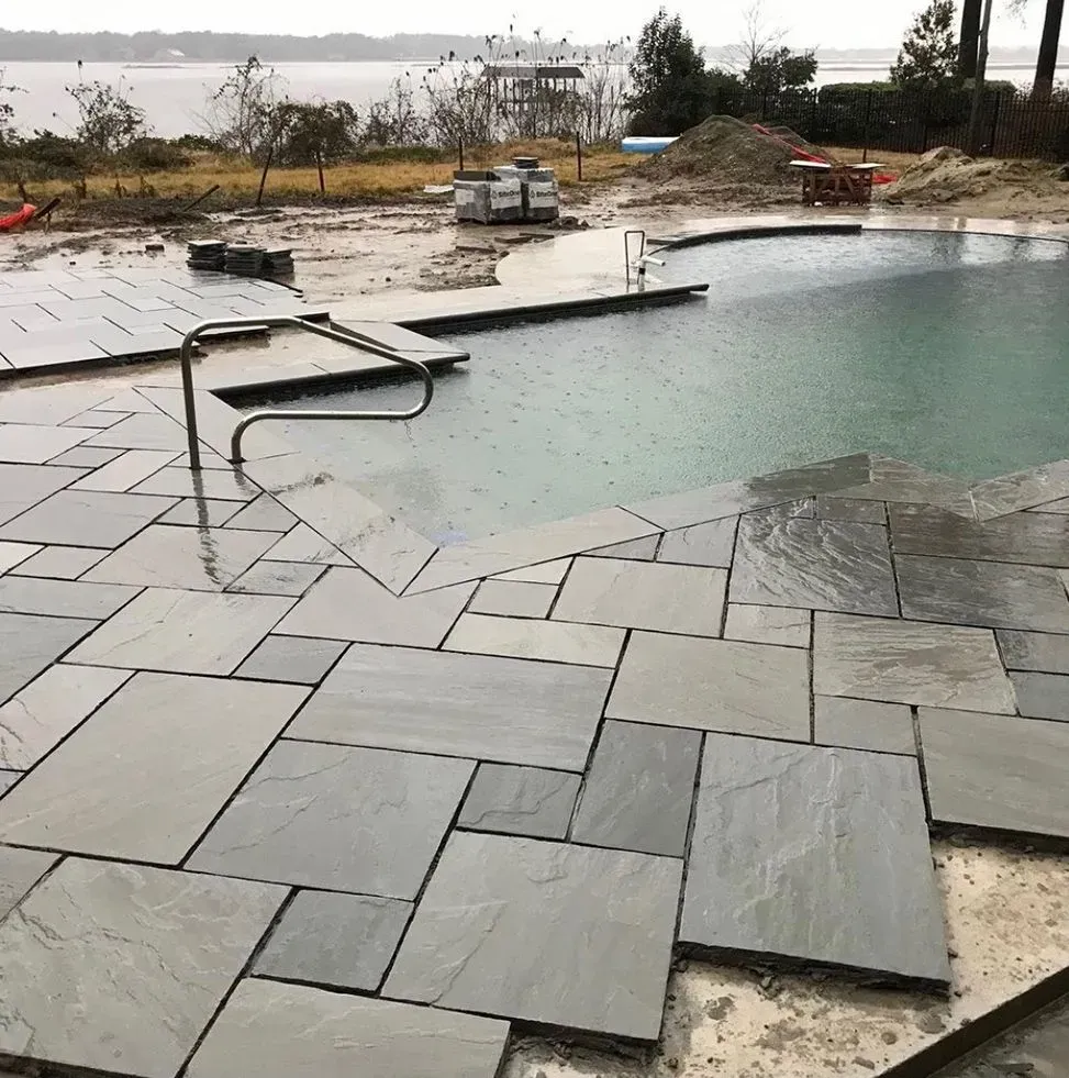 A large swimming pool with a staircase leading to it