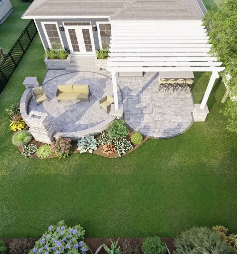 An aerial view of a house with a patio and a pergola.