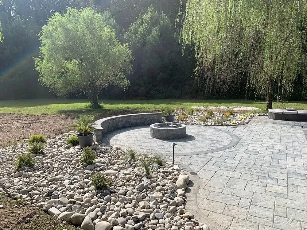 There is a fire pit in the middle of the patio.