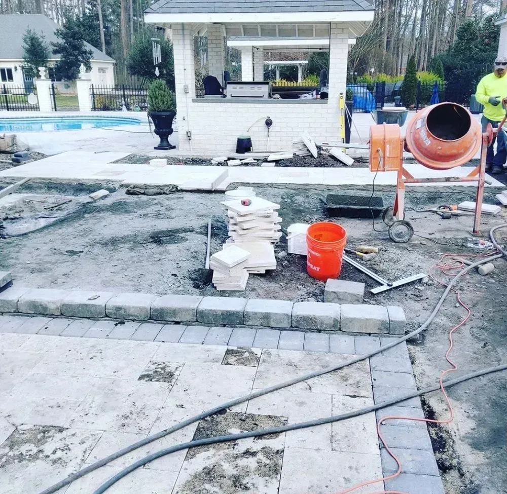 A construction site with a concrete mixer and buckets