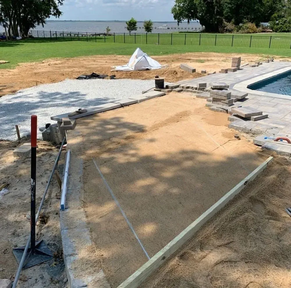 A construction site with a pool in the background