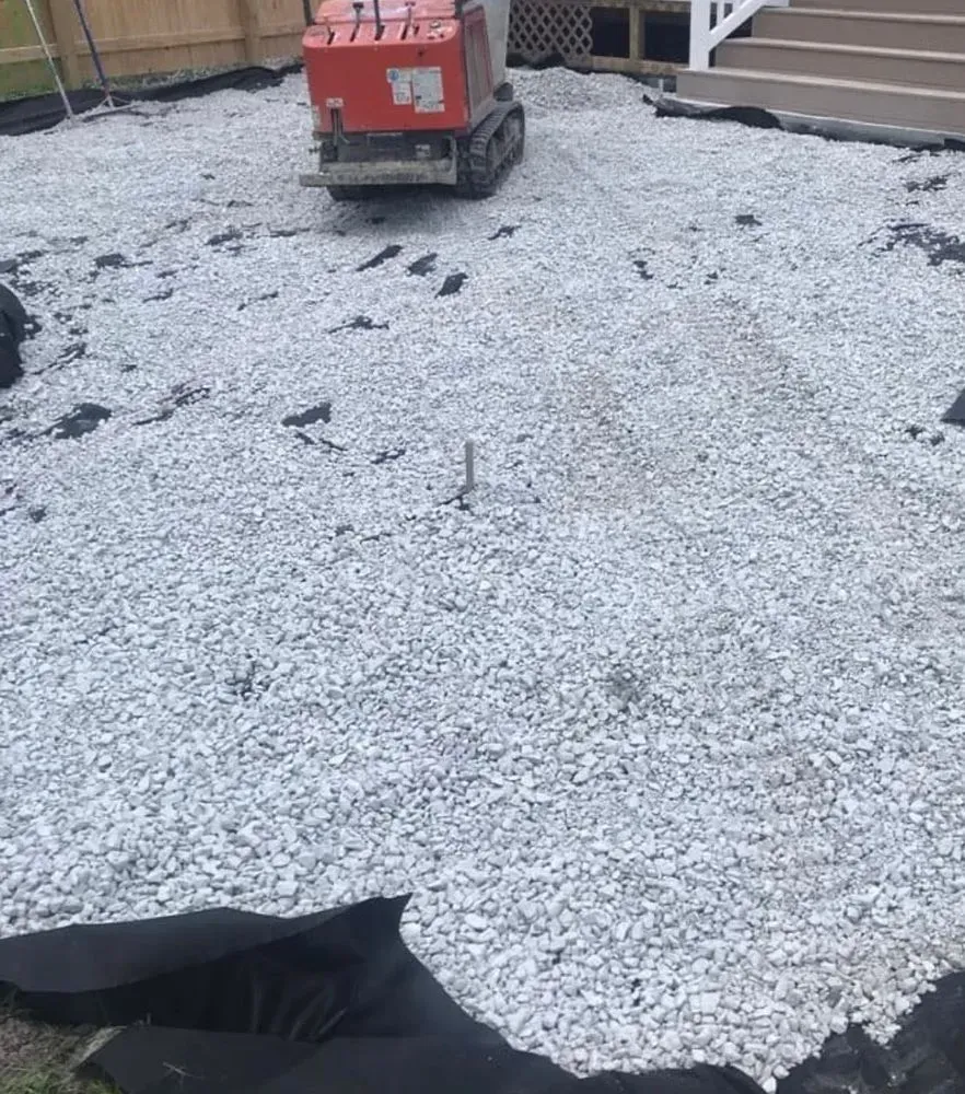 A machine is sitting on top of a pile of gravel.