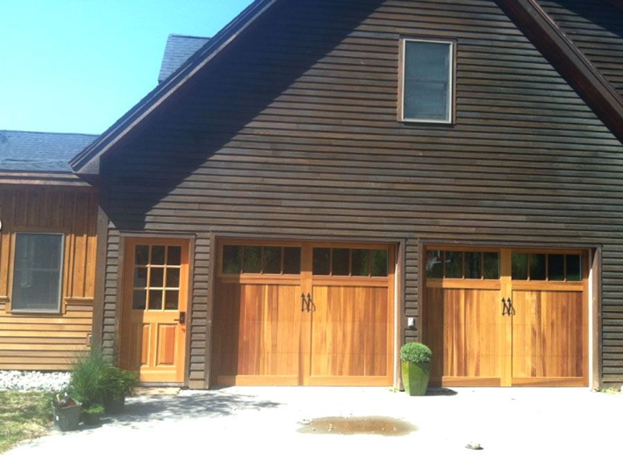 The front of a house with wooden garage doors