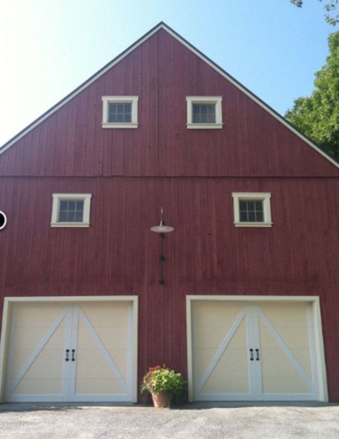 A large red barn with white doors and windows