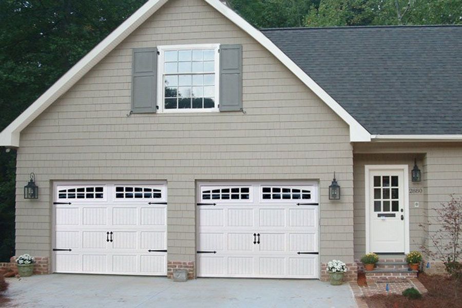 A house with two garage doors and a window