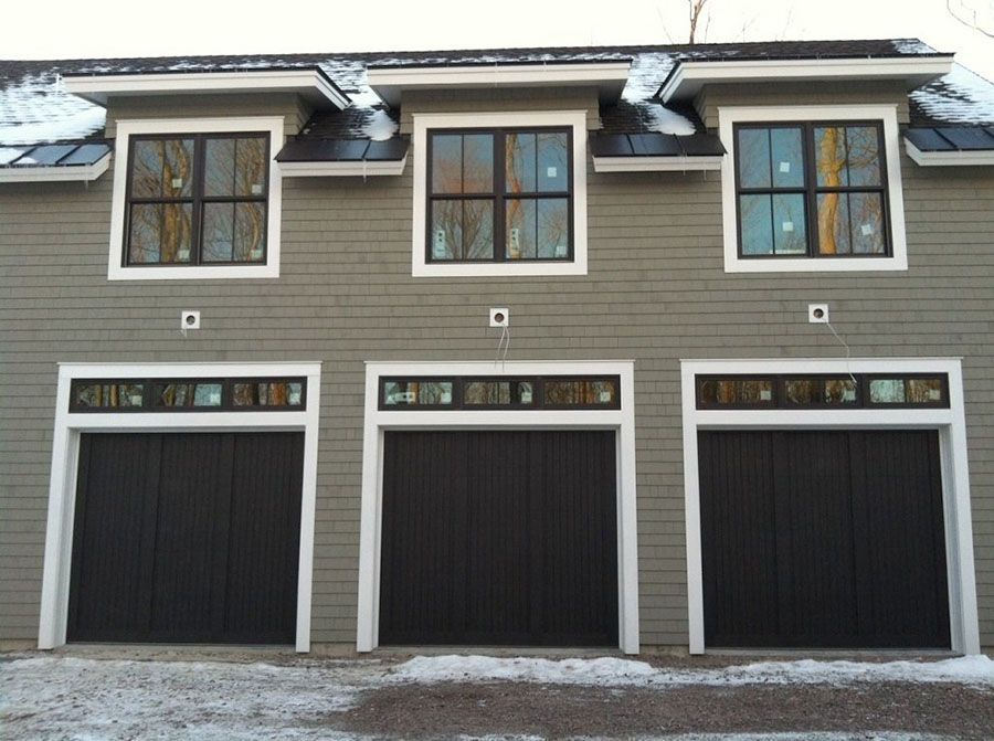 A building with three garage doors and three windows