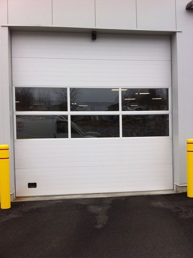A white garage door with a lot of windows