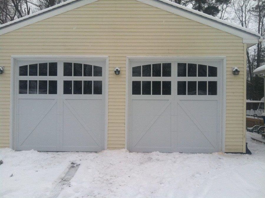 A garage with a lot of windows is covered in snow