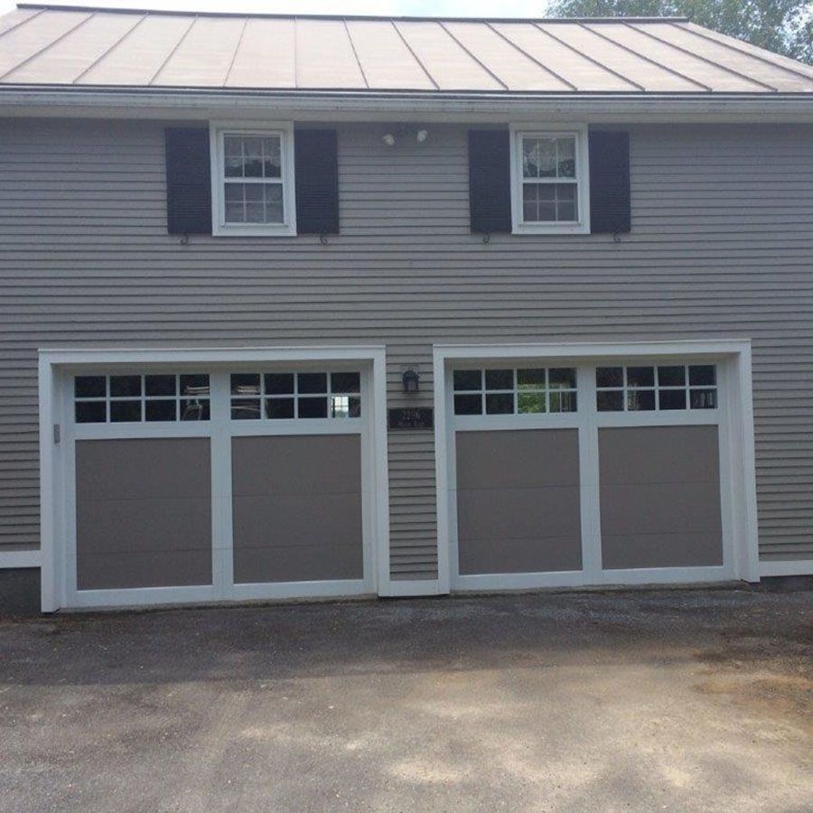 A house with two garage doors and two windows