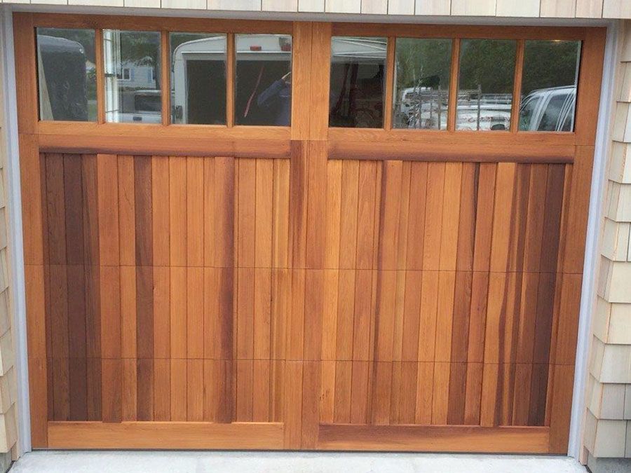 The garage door is made of wood and has a lot of windows