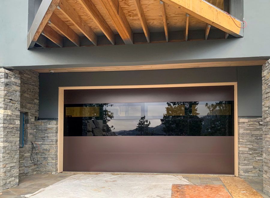 A brown garage door with a large glass window