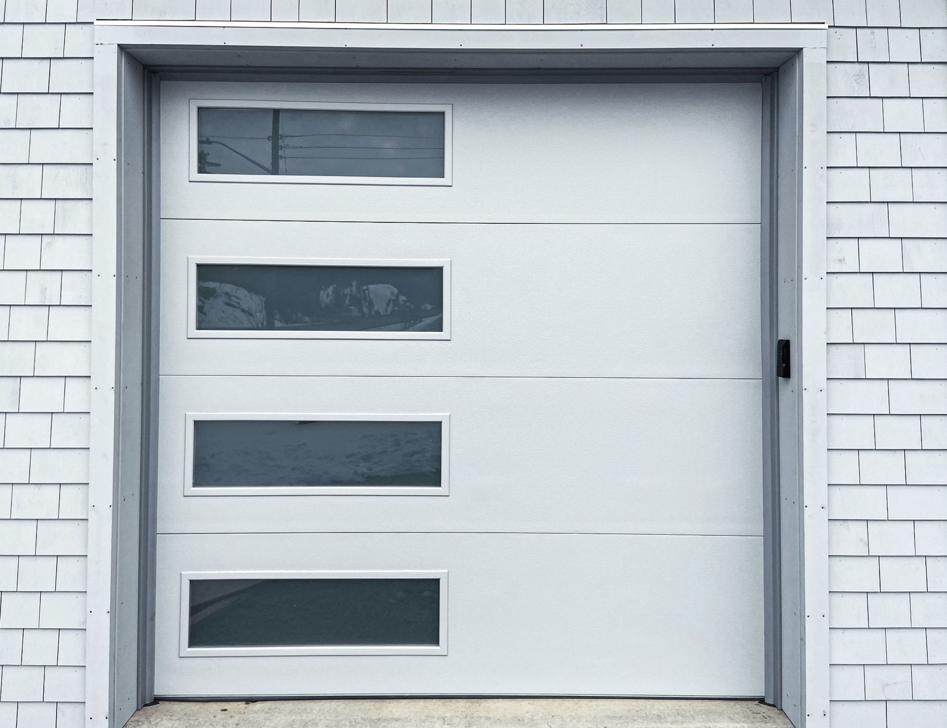 A white garage door with glass windows