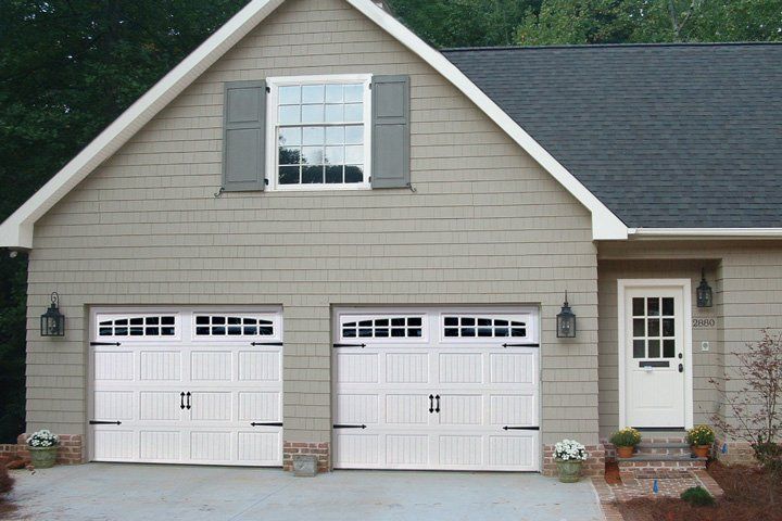 A house with two garage doors and a window