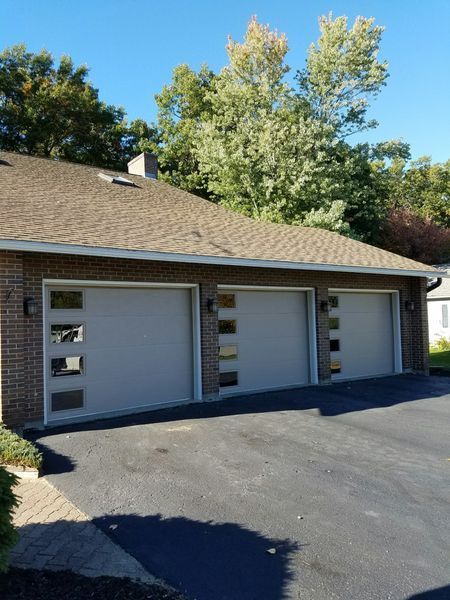 A house with three garage doors and a driveway
