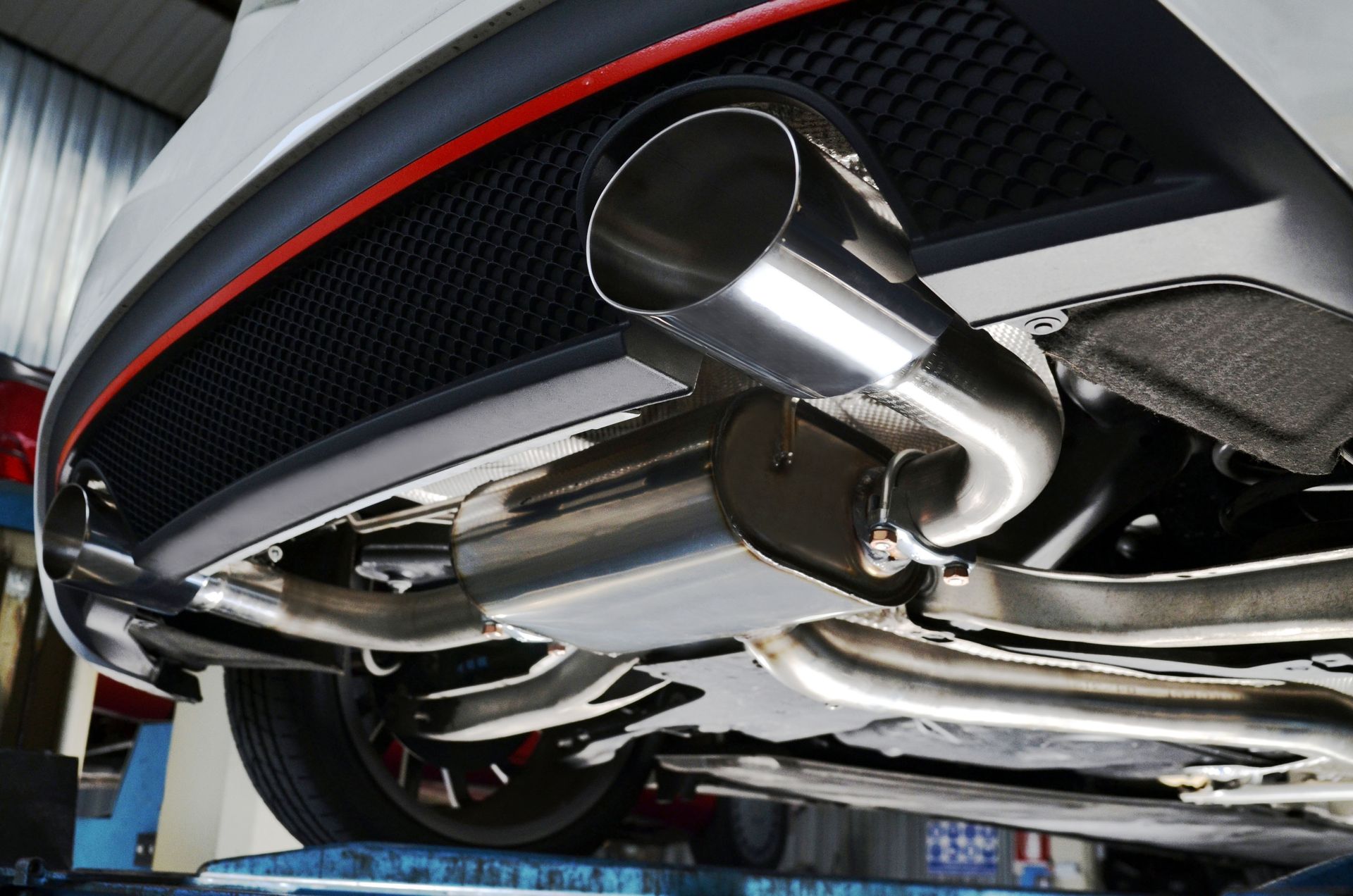 Stainless steel car exhaust system installed on a vehicle.