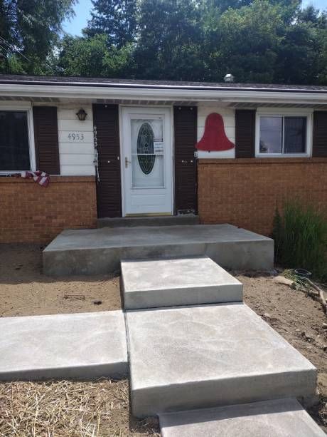 A brick house with concrete stairs