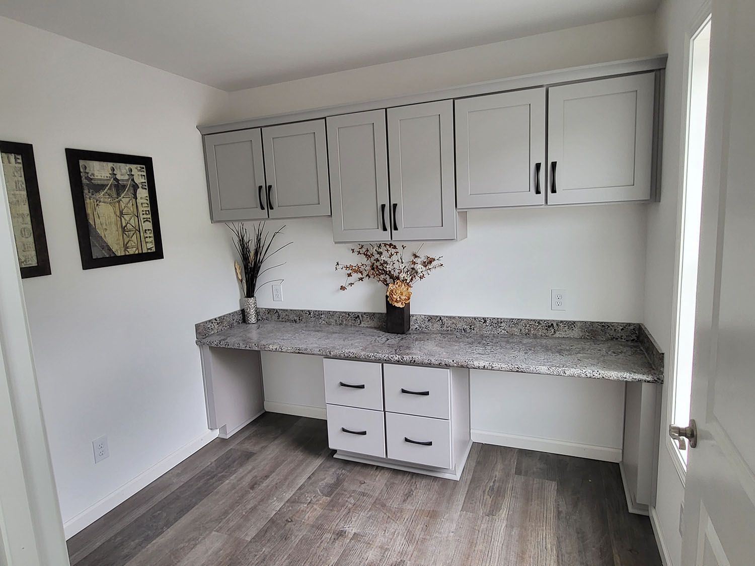 A room with a desk and cabinets