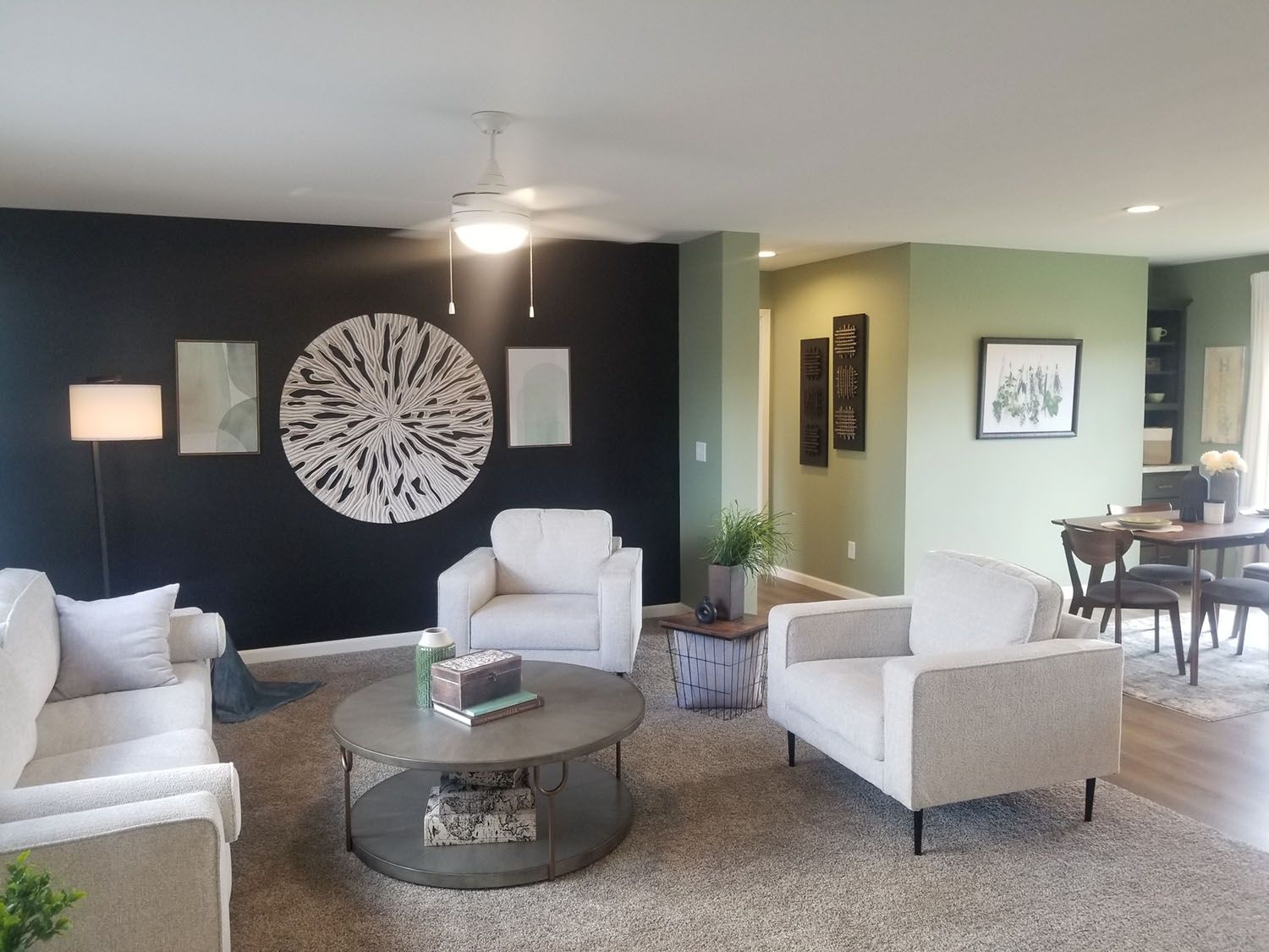 A spacious living room filled with furnitures