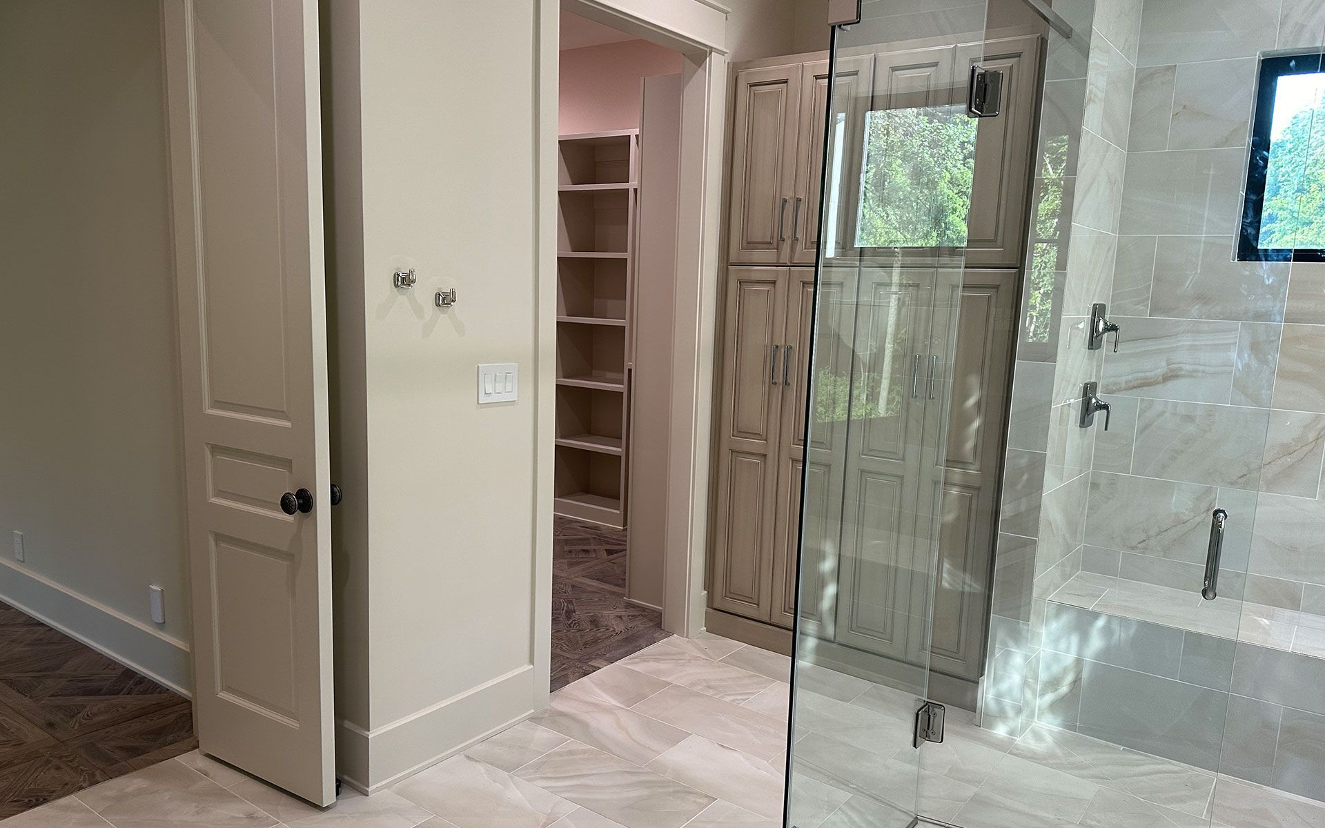 A bathroom with a walk in closet and a walk in shower.