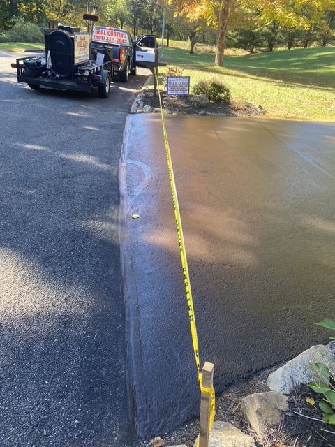 Road repair crew with paving machine beside a wet road and a flooded ditch, marked by yellow caution tape