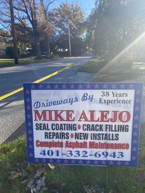 Blue roadside sign advertising driveway sealing, crack filling, and repairs on a sunny street.