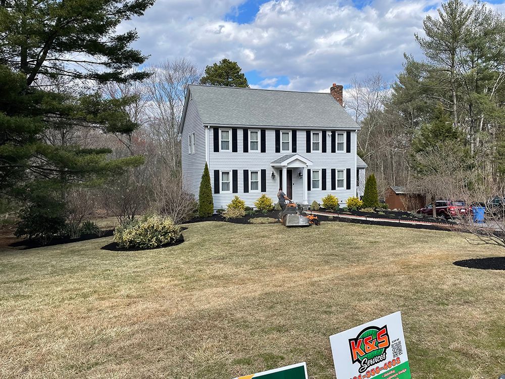 A house with a lush green lawn in front of it.