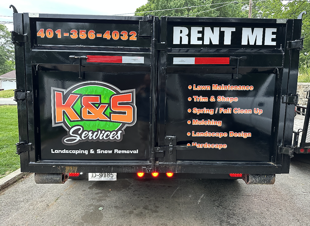 The back of a dumpster that says rent me on it