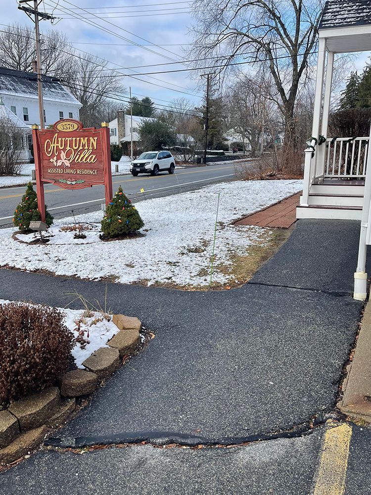 There is a sign on the side of the road that says autumn valley motel.