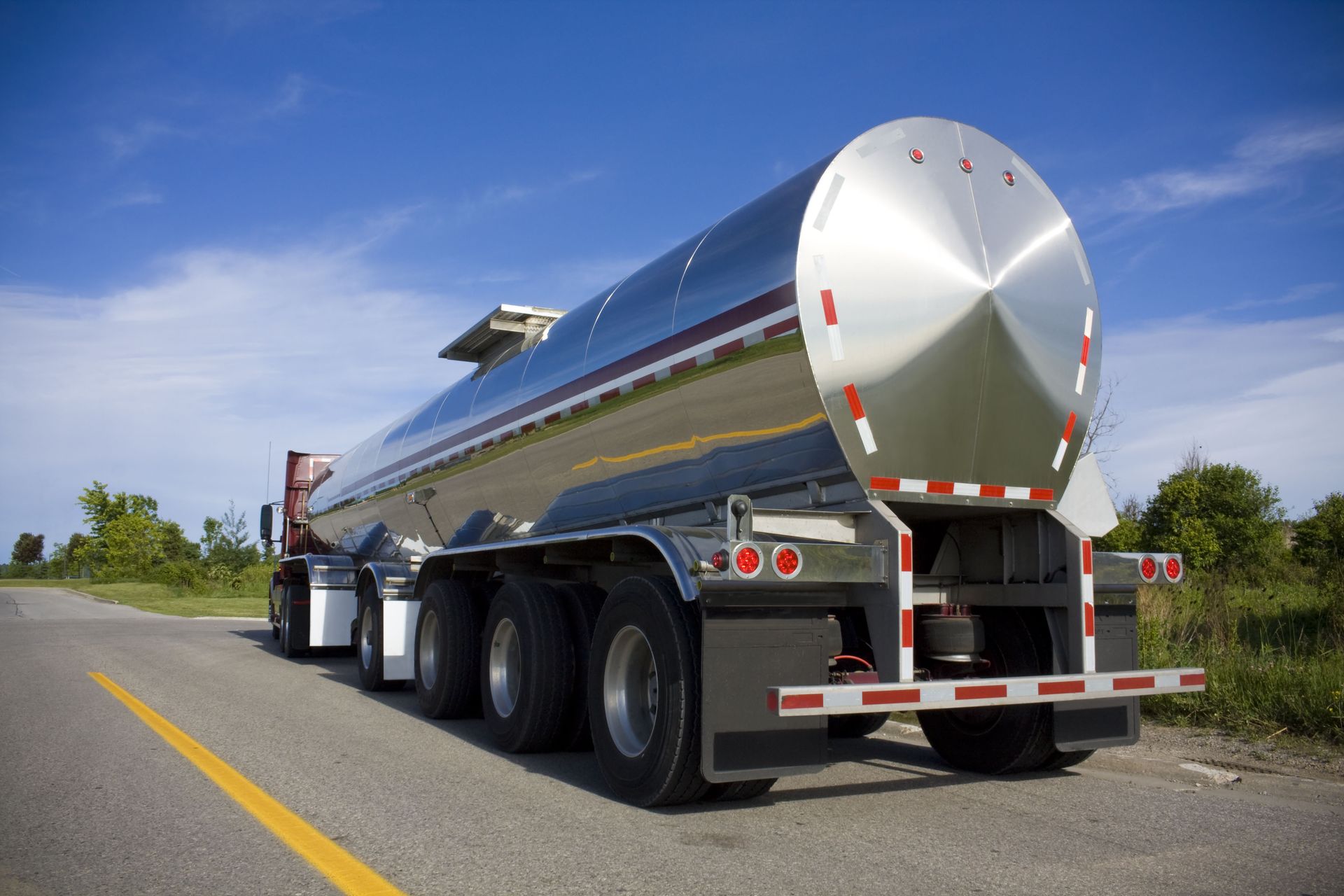 a tanker truck is parked on the side of the road
