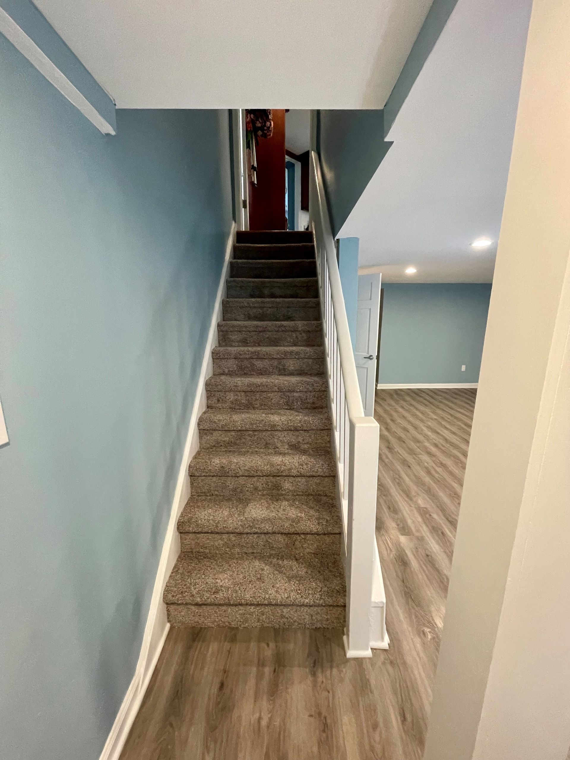 A set of stairs leading up to the second floor of a house.