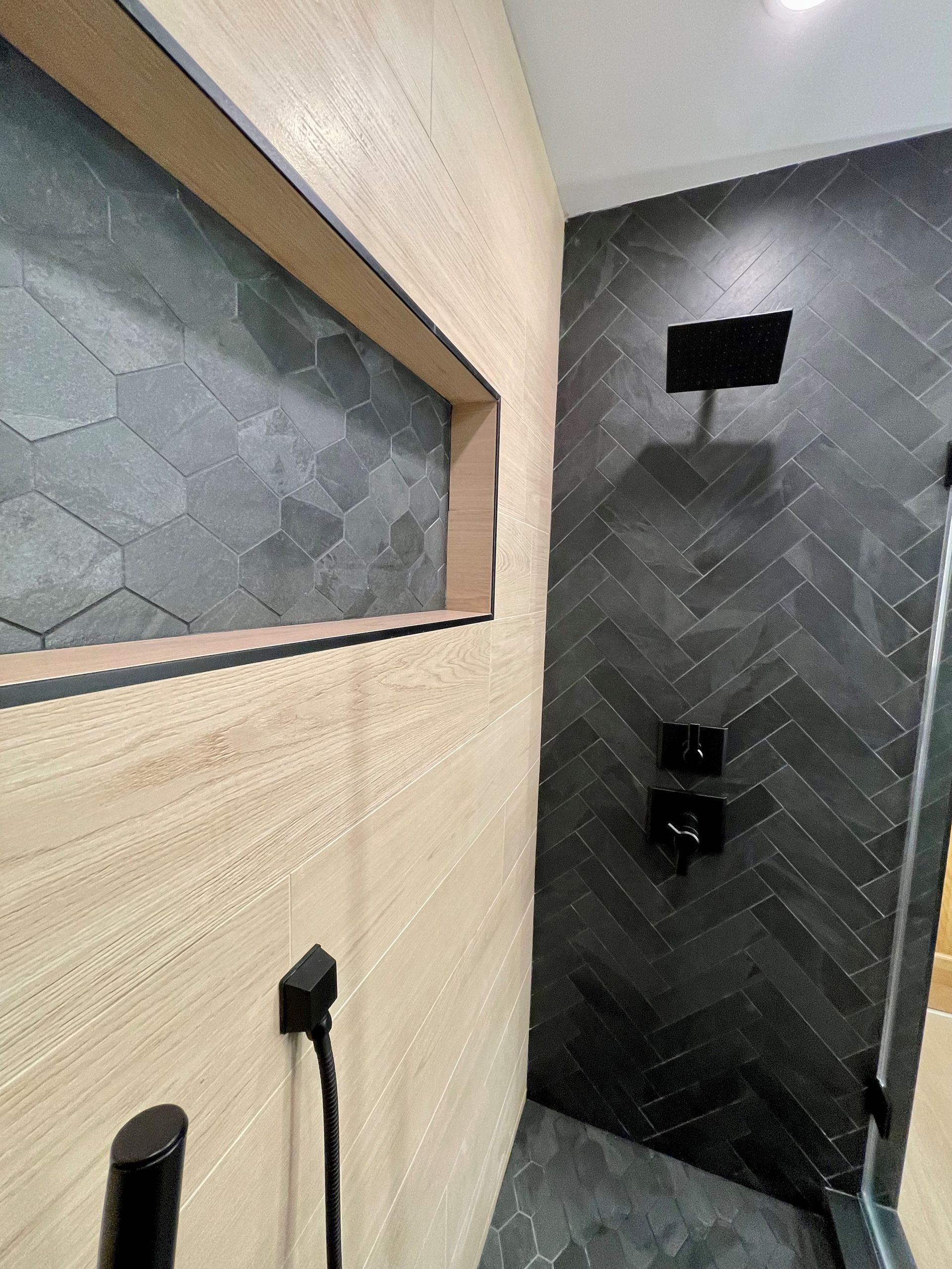 A bathroom with a shower and a window in the wall.