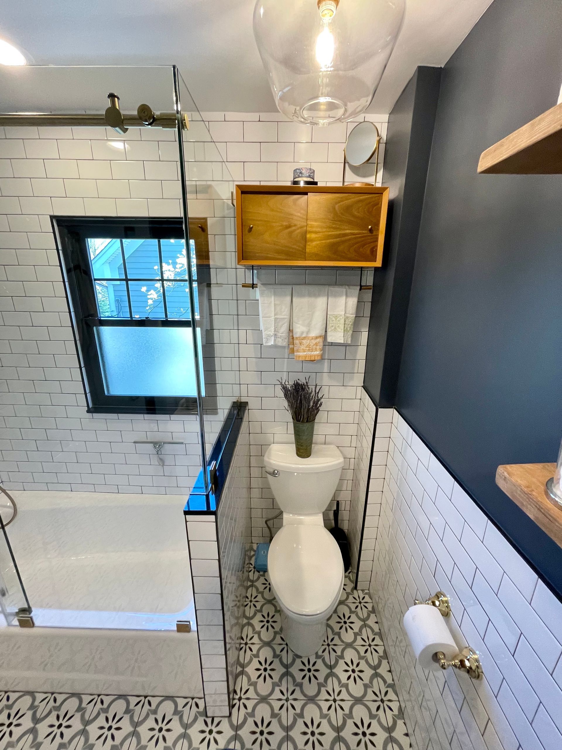 A bathroom with a toilet a bathtub and a window