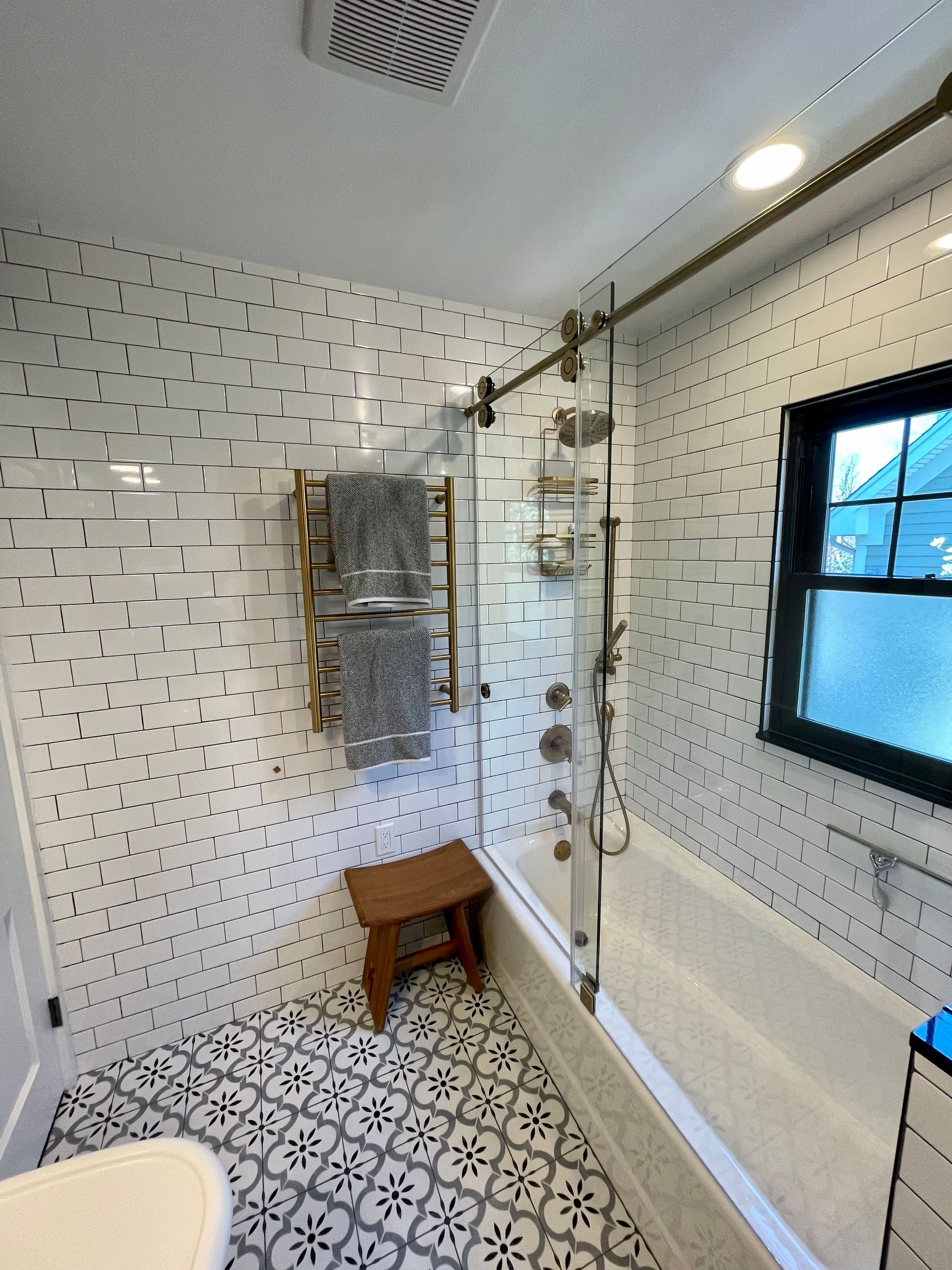 A bathroom with a bathtub and a window