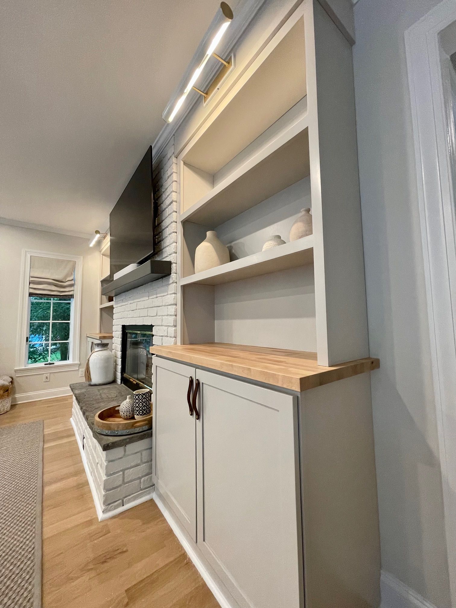 A living room with a fireplace and a bookshelf.