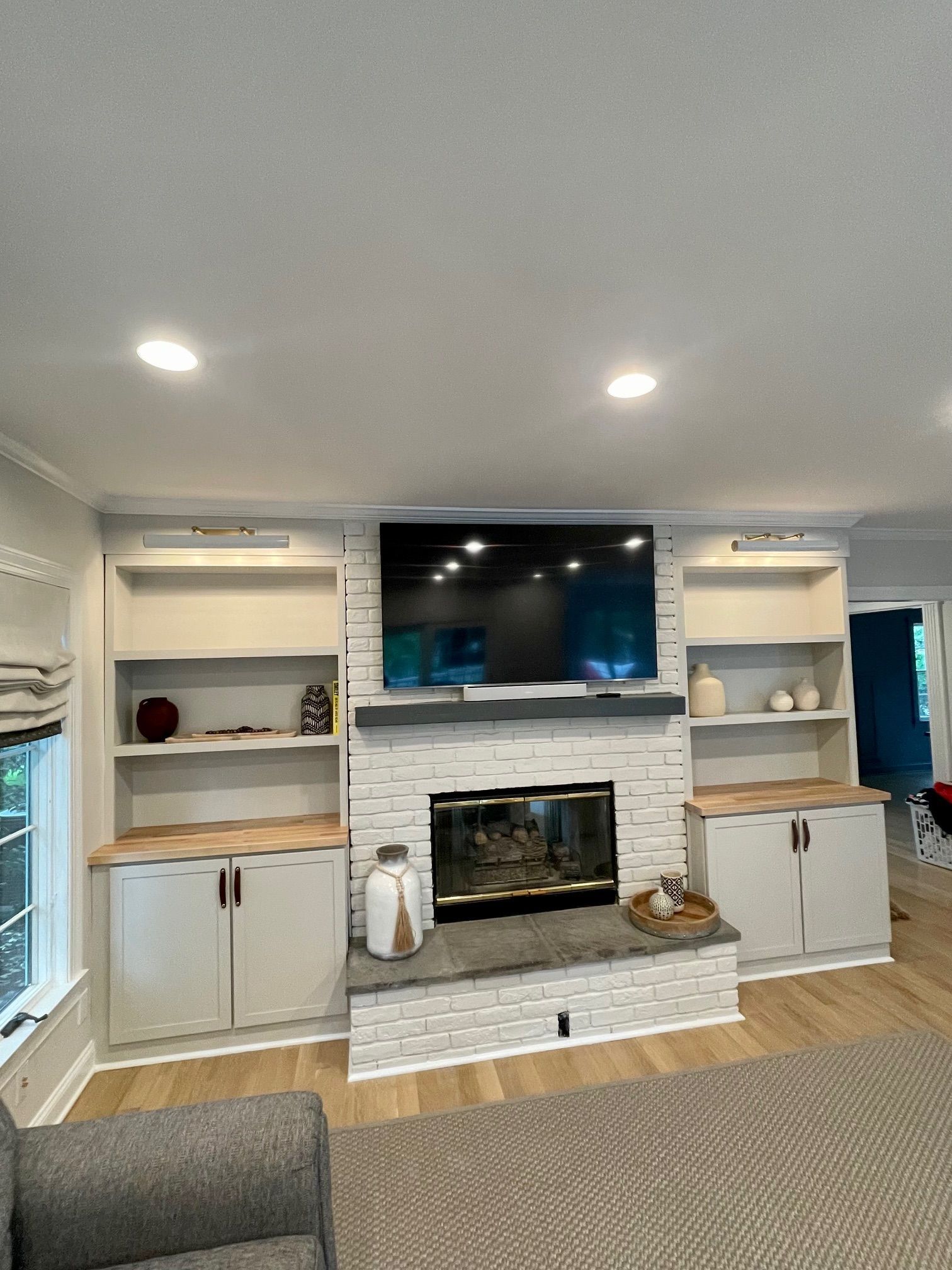 A living room picture with a fireplace and a flat-screen TV.