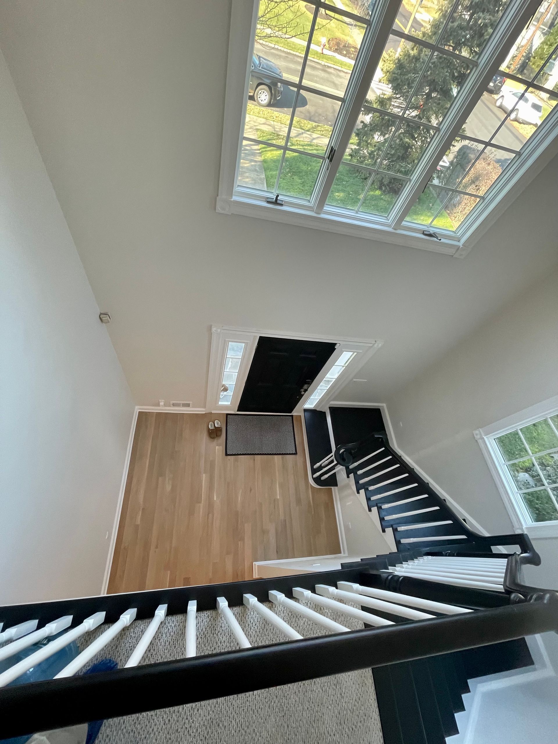 A view of a staircase from the second floor of a house.
