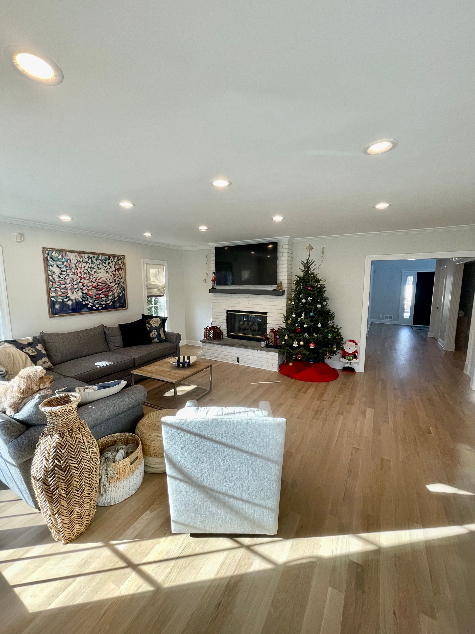 A living room filled with furniture and a christmas tree.