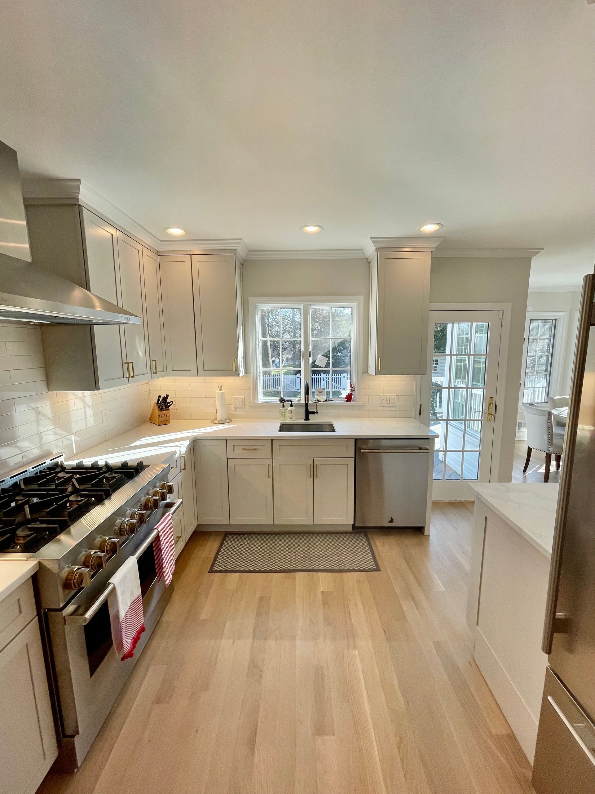 A kitchen with stainless steel appliances and white cabinets